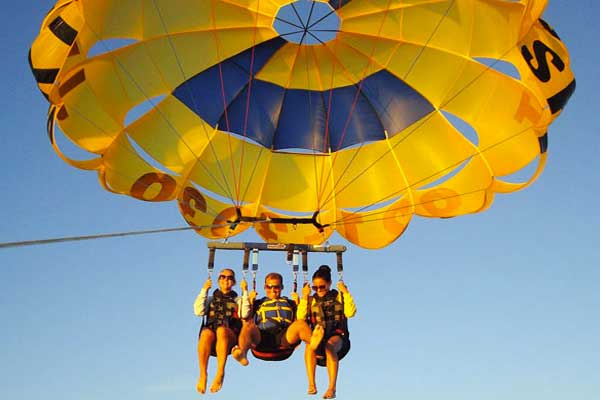 Tourist strapped into a Parasail